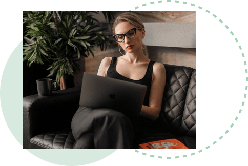 young woman sitting in a chair with a laptop on her lap