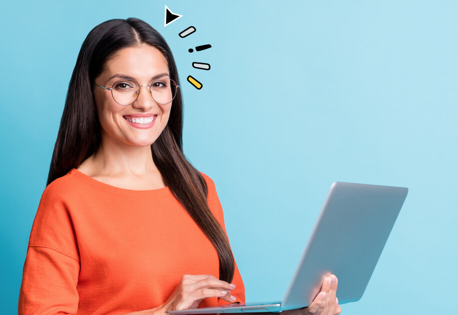 Smiling woman with glasses holding a laptop