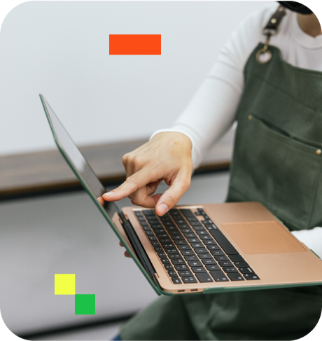 person pointing at laptop screen