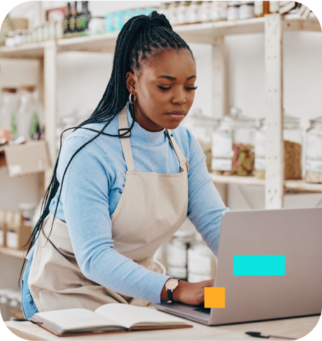 woman wearing apron on laptop