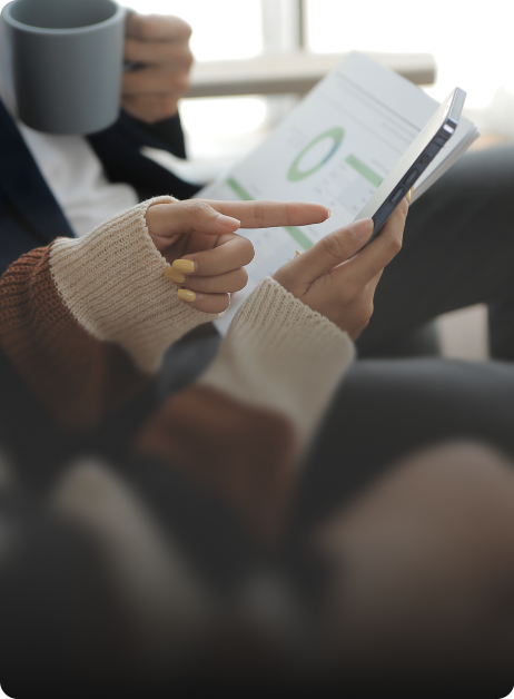 person pointing at printed graphs