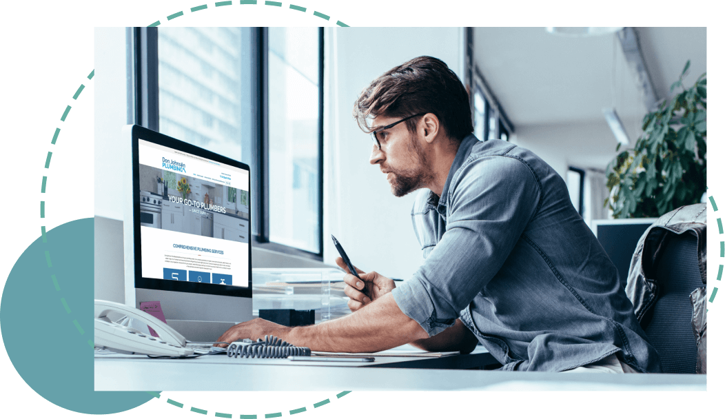 Man sitting in front of a desktop reviewing a website